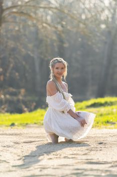 A gorgeous blonde model enjoys a spring day outdoors