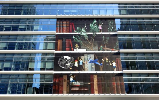 KAOHSIUNG, TAIWAN -- APRIL 18, 2015: The modern facade of the newly built Kaohsiung Main Public Library is decorated with a large art display.
