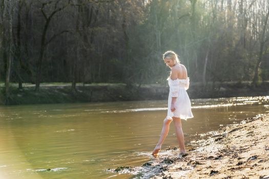 A gorgeous blonde model enjoys a spring day outdoors