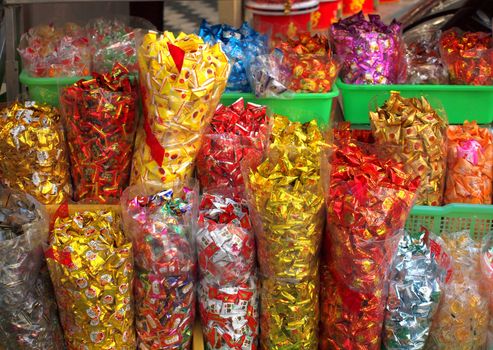 KAOHSIUNG, TAIWAN -- JANUARY 28, 2014: Large sacks of candy at an outdoor store. At Chinese New Year it is customary for people to have a variety of sweets on hand to offer to guests. 
