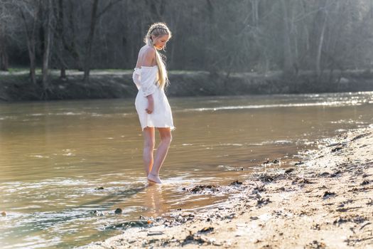 A gorgeous blonde model enjoys a spring day outdoors