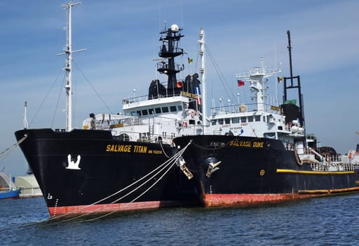 KAOHSIUNG, TAIWAN -- MAY 26, 2018: Two large ocean-going tugs are anchored in the busy port of Kaohsiung, a major trading hub for Taiwan.
