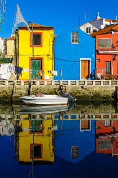 View of canals, boats, colorful houses, and laundry, in Aveiro, Portugal