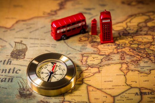 London map with Big Ben, double decker bus in miniature and compass, travel concept. England, UK.