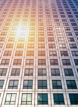 Sun ray and blue sky reflection on window office building, business concept