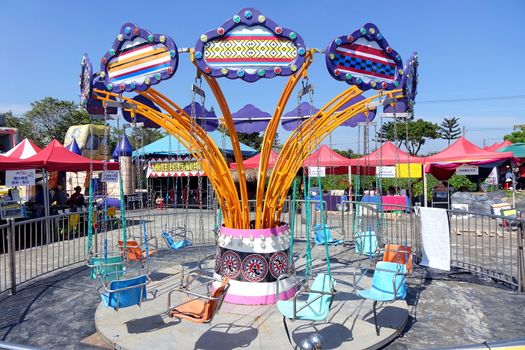 PINGTUNG, TAIWAN -- FEBRUARY 14, 2018: A traditional old style merry-go-round provides entertainment for children at the Pingtung Tropical Agricultural Fair.