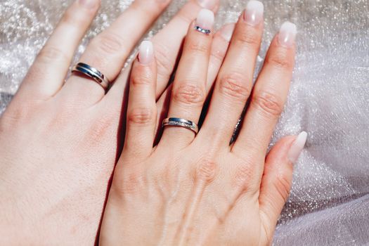 Newly wed couple's hands with wedding rings