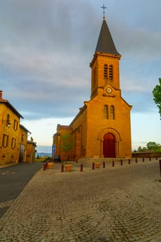 Village center and the church, at sunrise, in Moire, Beaujolais, Rhone department, France