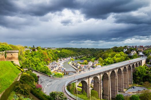 Aerial view of the historic town of Dinan with Rance river with dramatic cloudscape, Cotes-d'Armor department. Brittany (Bretagne), France