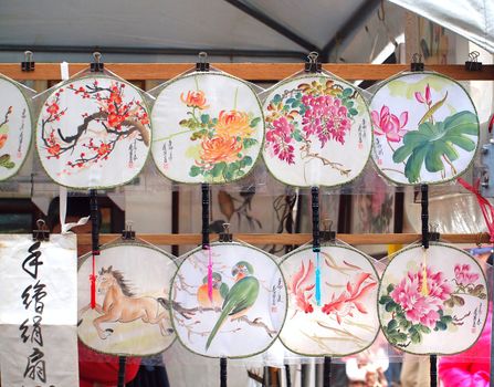 A New Year's outdoor market sells traditional Chinese hand-painted fans
