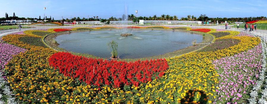 PINGTUNG, TAIWAN -- FEBRUARY 14, 2018: A large fountain surrounded by colorful flower beds greets visitors at the Pingtung Tropical Agricultural Fair.
