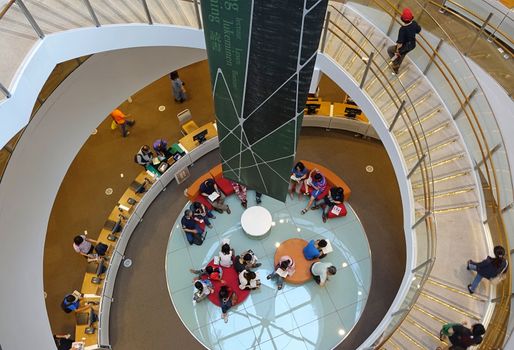 KAOHSIUNG, TAIWAN -- APRIL 18, 2015: A reading area and circular staircase in the newly built Kaohsiung Main Public Library.
