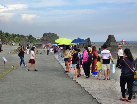 KAOHSIUNG, TAIWAN -- JULY 27, 2019: Tourists at the Black Sand Beach festival on Chijin Island.