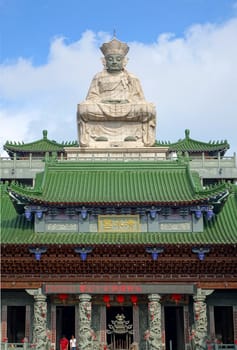 KAOHSIUNG, TAIWAN -- MAY 25, 2014: The Qing Shui Temple on the west side of the Lotus Lake was originally built in 1885. The large deity statue was added later.