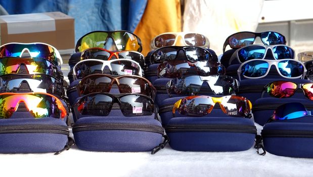 KAOHSIUNG, TAIWAN -- OCTOBER 11, 2014: An outdoor vendor on Cijin Island tourist market sells reflecting sunglasses.