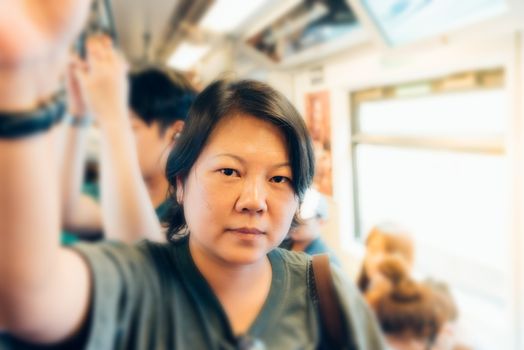 People travel on BTS skytrain train runs in Bangkok. Many people in Bangkok used skytrain to save time.