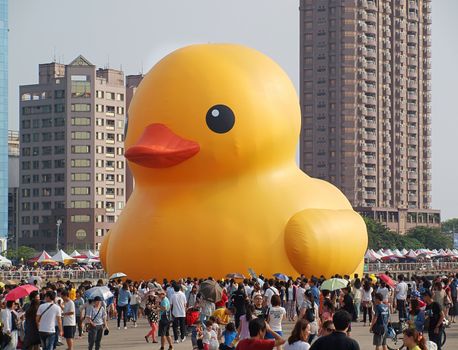 KAOHSIUNG, TAIWAN -- SEPTEMBER 28: Visitors flock to see the giant rubber duck designed by Dutch artist Hofman while it is on display at the Glory Pier on September 28, 2013 in Kaohsiung