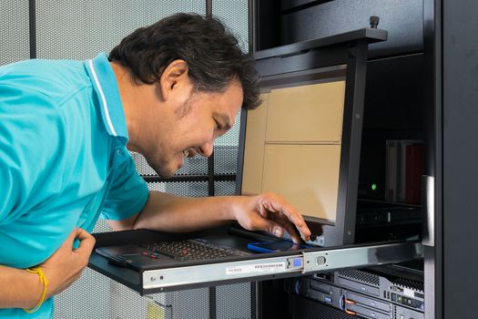 Asia man pain from disease heart attack when working on computer server