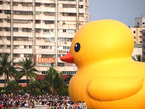 KAOHSIUNG, TAIWAN -- SEPTEMBER 28: Visitors flock to see the giant rubber duck designed by Dutch artist Hofman while it is on display at the Glory Pier on September 28, 2013 in Kaohsiung