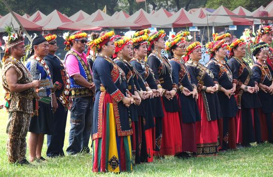 KAOHSIUNG, TAIWAN -- SEPTEMBER 28, 2019: Men and women of the indigenous Rukai tribe perform a dance during the traditional harvest festival.