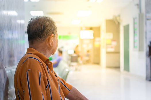 Patient elderly and many patient waiting a doctor and nurse in hospital , process in soft orange sun light style