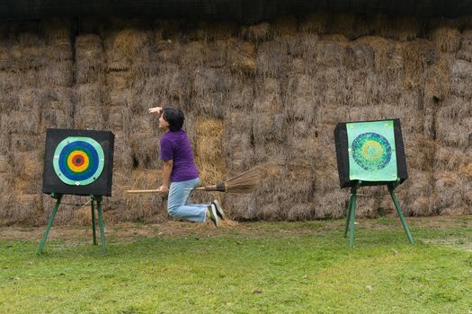 Asia woman plump body is a witch riding a broom flying to archer target