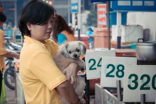 The cute dog and Thai women in market , process in vintage style