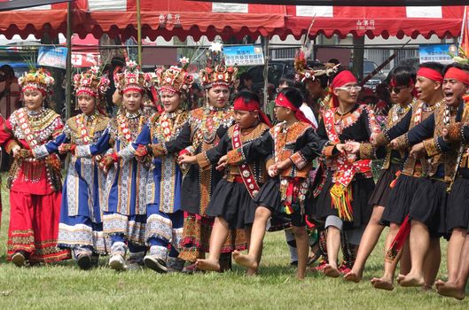 KAOHSIUNG, TAIWAN -- SEPTEMBER 28, 2019: Men and women of the indigenous Rukai tribe perform a dance during the traditional harvest festival.