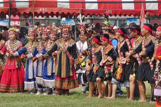 KAOHSIUNG, TAIWAN -- SEPTEMBER 28, 2019: Men and women of the indigenous Rukai tribe perform a dance during the traditional harvest festival.