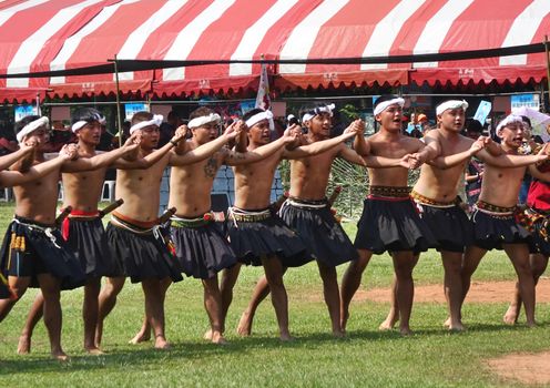 KAOHSIUNG, TAIWAN -- SEPTEMBER 28, 2019: Young men of the indigenous Rukai tribe perform a dance during the traditional harvest festival.
