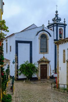 Christmas ornament and Sao Pedro church in Obidos, Portugal
