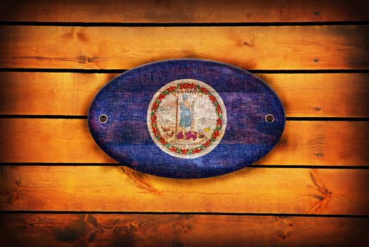 Virginia flag on brown wooden planks.