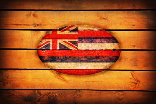 Hawaii flag on brown wooden planks.