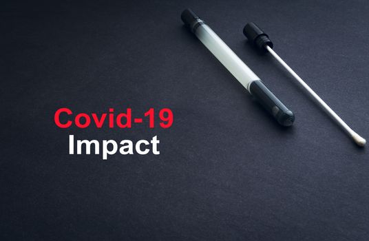 COVID-19 or CORONAVIRUS IMPACT text with medical swab on black background. Covid-19 or Coronavirus concept. 