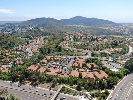 Aerial view middle class neighborhood with condo community and residential house and mountain on the background in Rancho Bernardo, South California, USA.