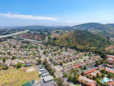 Aerial view middle class neighborhood with condo community and residential house and mountain on the background in Rancho Bernardo, South California, USA.