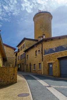 Street in the medieval village Oingt, and the keep tower, in Beaujolais, Rhone department, France