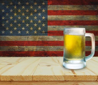 Glass of beer on wooden table. USA flag background celebrate American Independence Day of 4th July