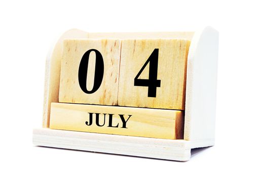 Cube shape calendar for July 04 on wooden surface isolated with clipping path