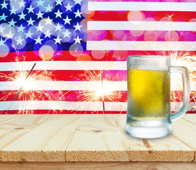 Glass of beer on wooden table. USA flag with sparklers background celebrate American Independence Day of 4th July