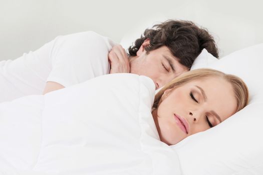 Portrait of couple sleeping in the bed close up focus on woman