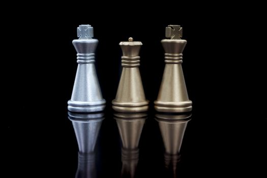 Stacking Piece of chess, king and queen with reflection glass on black background. 