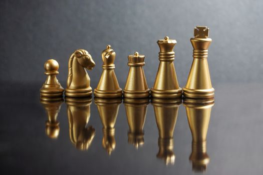 Stacking Piece of chess, king, queen, knight, castle, bishop and  pawn or apieces with reflection glass on black background. Chess game, business, competition, leadership and success concept