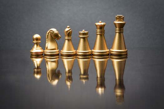 Stacking Piece of chess, king, queen, knight, castle, bishop and  pawn or apieces with reflection glass on black background. Chess game, business, competition, leadership and success concept