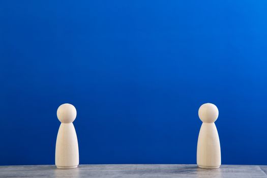 Social distancing conceptual image. wood figurine of people keep social distancing.