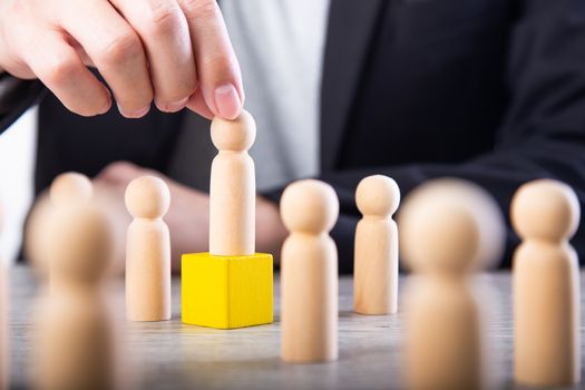 successful team leader, businessman hand choose people standing out from the crown.