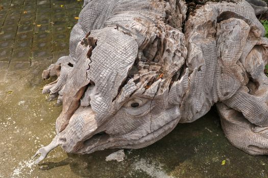 Wooden statue of a lizard. Art and work of Balinese artists. Wooden art. Komodo dragon made of piece of old wood. Big varan art statue from wooden pieces. Ubud, Bali, Indonesia. March 2020.