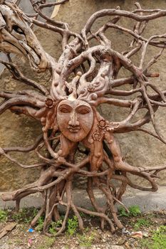 Sun with face made of tree root. Wooden decoration. Dried fibrous roots that spread beautifully to the soil surface. can be used as a background template.Art and work of Balinese artists. Ubud, Bali.