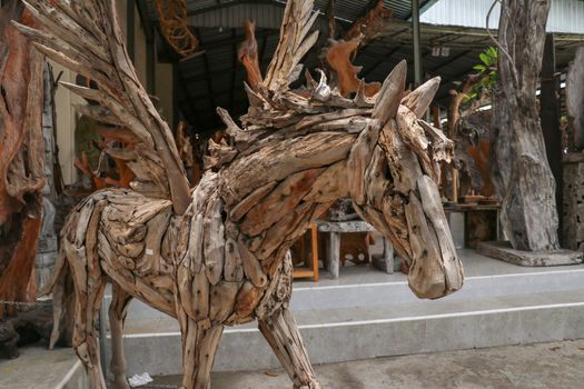 Pegasus horse statue. Art and work of Balinese artists. Wooden art. A winged horse made of wooden pieces. Big horse head art statue from wooden pieces. Ubud, Bali, Indonesia.
