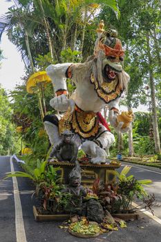 Statue of Hanuman, Hindu god and divine monkey - vanara companion of the god Rama, holding gada - mace. Bali, Indonesia. Colorful Beautiful Statue Of Indian Lord God Idol Sankatmochan Jai Hanuman.